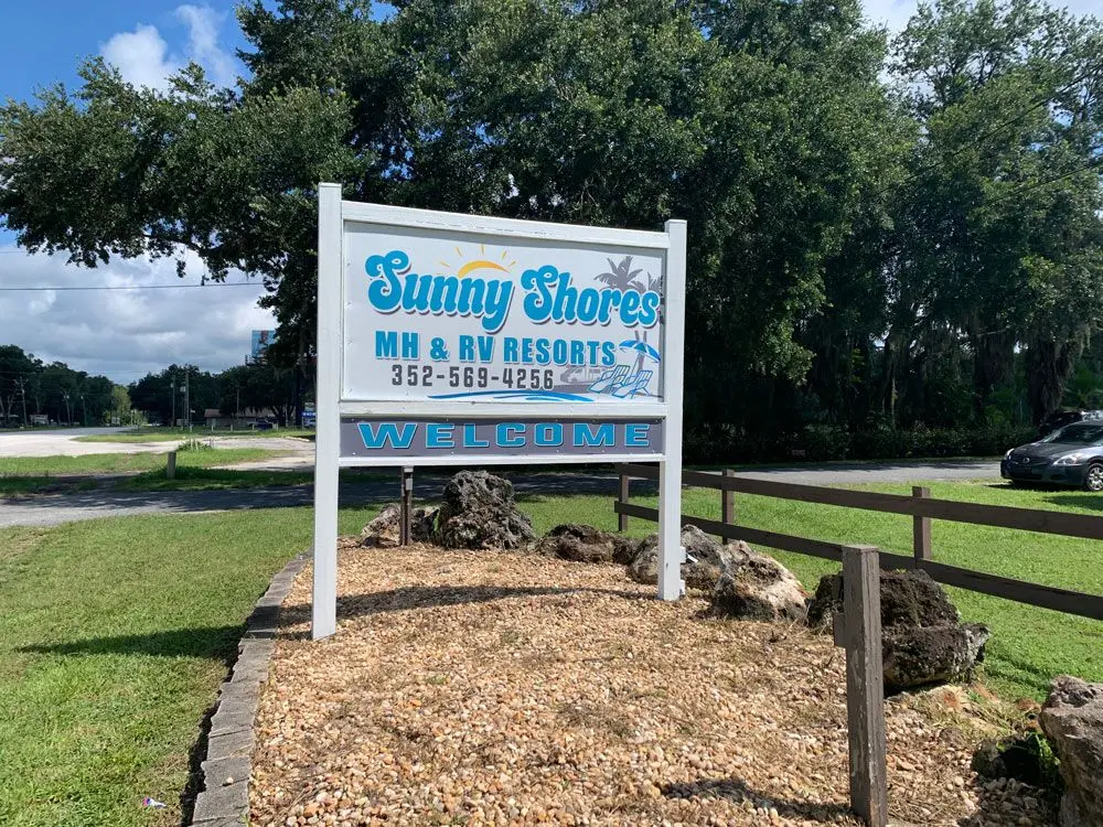 Sunny Shores MH & RV Resort welcome sign at the park entrance